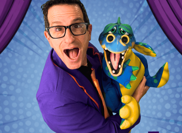 The Magician, WonderPhil, standing with his dragon puppet