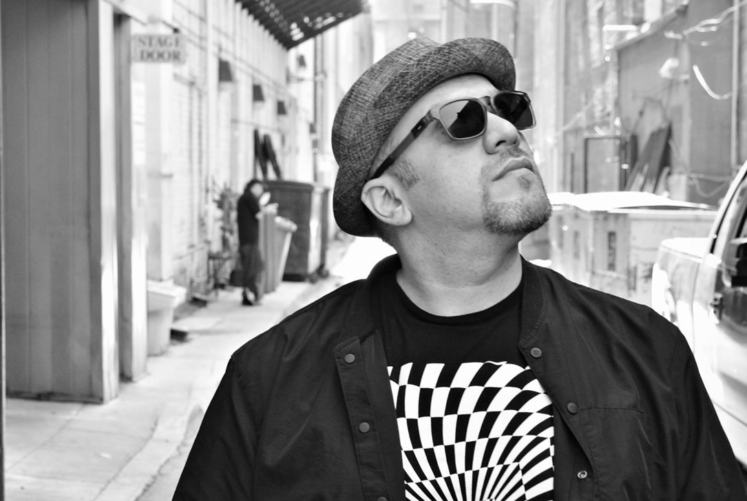 Robi looks up. He wears a fedora.