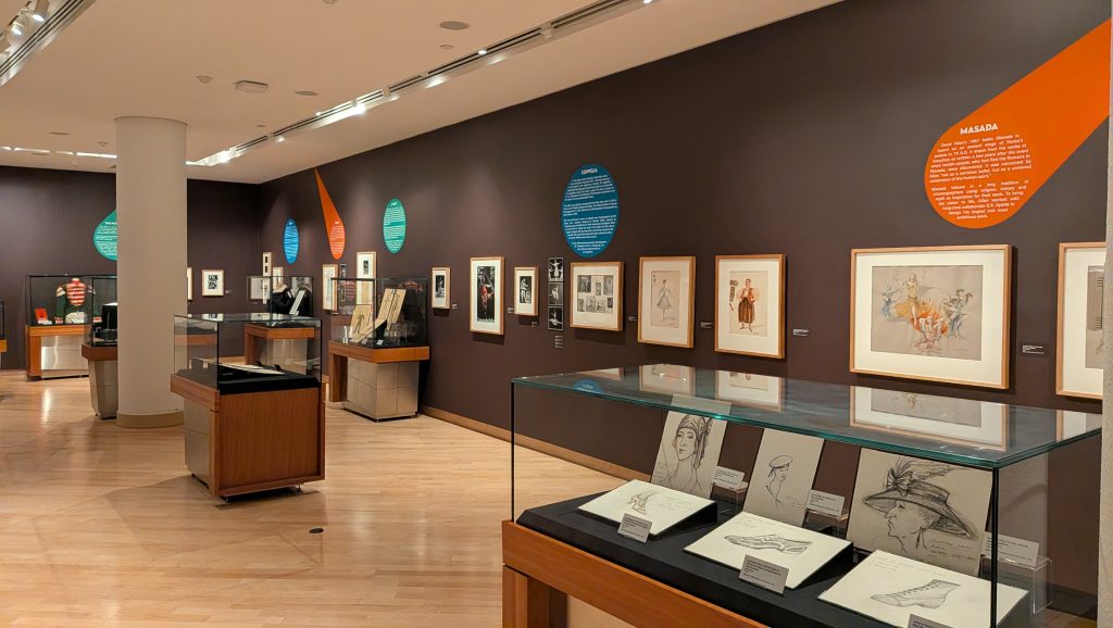 Internal Gallery image with art on the wall and items in display cases
