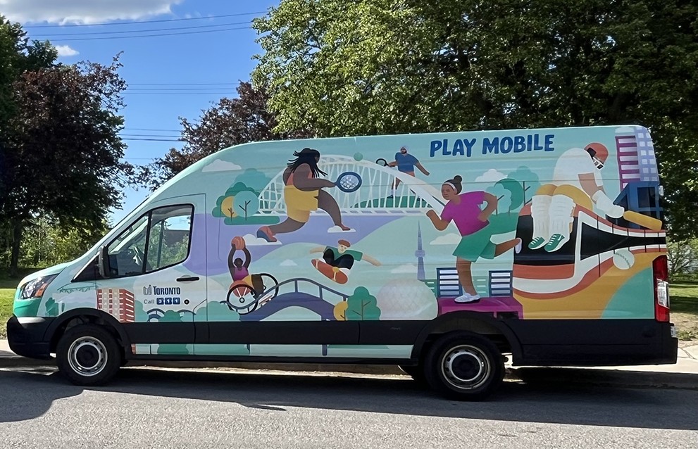 A brightly painted van  depicting people playing sports that reads Play Mobile on the side.