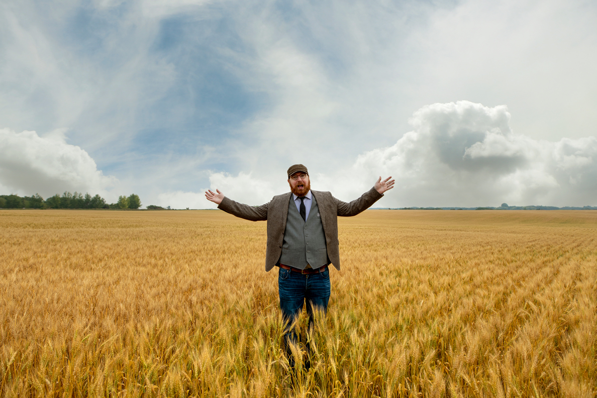 Man standing in a field of wheat