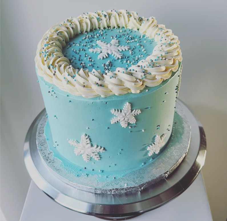 A cake with blue and white winter-holidays-themed cake