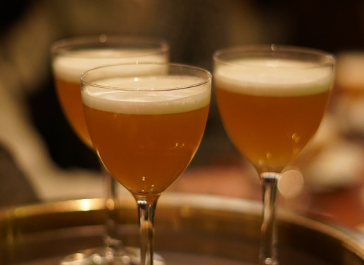Three bellinis in glasses.