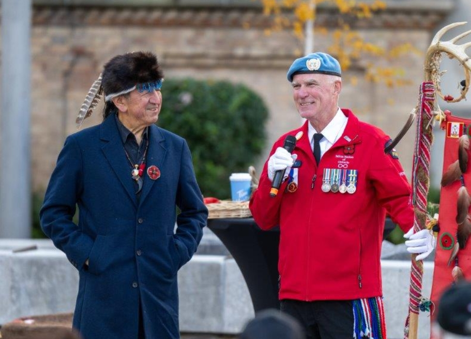 Elder and Metis Veteran with an Eagle Staff