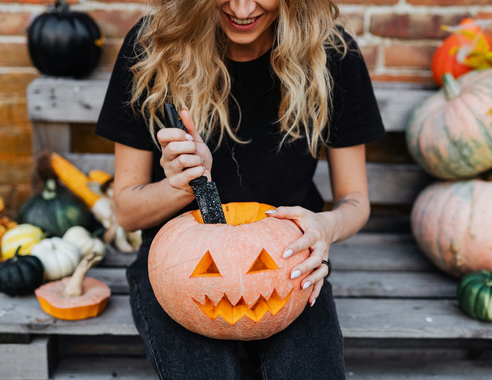 Woman Holding  a Carved Pumpkin
