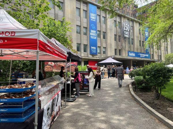 several booth in front of sick kids hospital with customers shopping