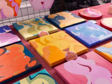 A table with many colourful paintings of different figures