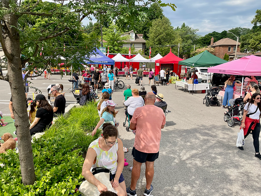 Crowd of people and vendor tents at The Eglinton Way Farmers' Market
