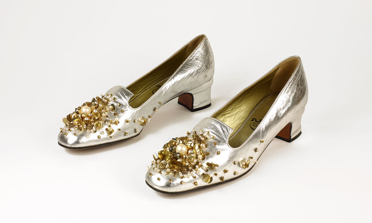 A pair of silver pump heels with beaded vamps
