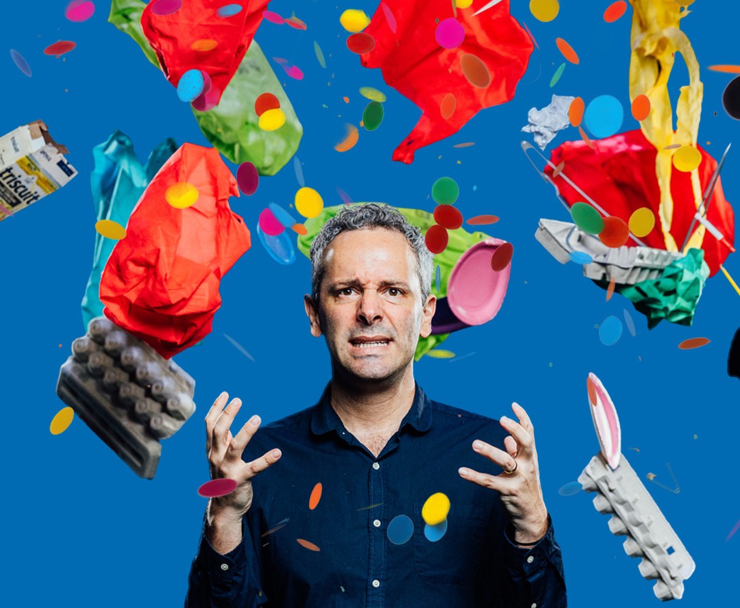 A man with a frustrated look is surrounded by grocery bags, egg cartons, confetti and paper plates thrown in the air