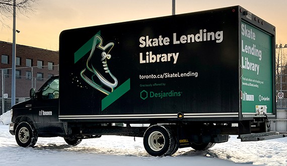 A cargo van branded with Skate Lending Library and Desjardins logo.