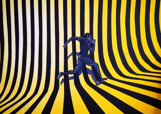 man running on a yellow and black striped background
